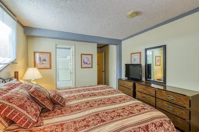 a bedroom with a large bed and a television at Mammoth Ski & Racquet 124 in Mammoth Lakes