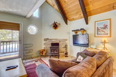 a living room with a couch and a tv and a fireplace at Mammoth View Villas 30 in Mammoth Lakes