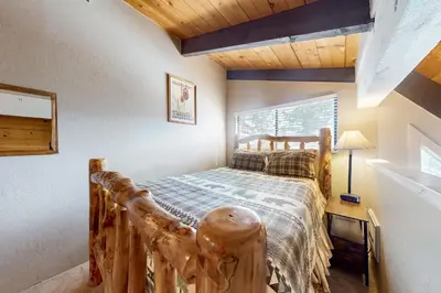 a bedroom with a bed made out of logs at Mammoth View Villas 30 in Mammoth Lakes