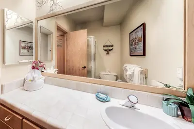 a bathroom with a sink and a large mirror at Snowcreek 847 in Mammoth Lakes