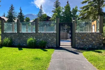a gate to a stone fence with a stone wall at Snowcreek 847 in Mammoth Lakes