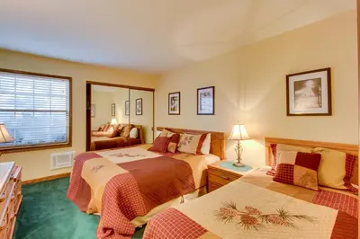 a bedroom with two beds and a window at Sierra Megeve 9 in Mammoth Lakes
