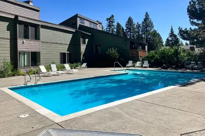 a swimming pool in front of a house at The Summit 67 in Old Mammoth