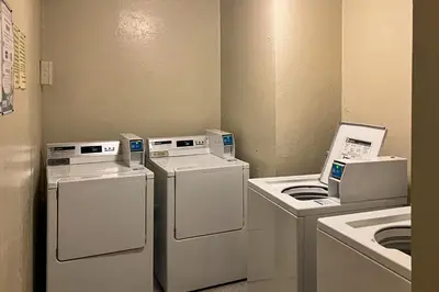 a laundry room with three machines and a washer and dryer at The Summit 67 in Old Mammoth