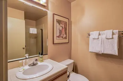 a bathroom with a sink and a toilet and a mirror at The Bridges 23 in Mammoth Lakes