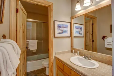 a bathroom with a sink and a toilet and a mirror at Snowcreek 233 in Mammoth Lakes