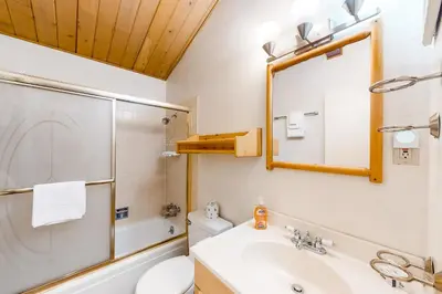 a bathroom with a shower toilet and a sink at Timberline 35 in Mammoth Lakes
