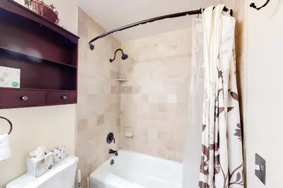 a bathroom with a tub and a shower curtain at Val D'Isere 26 in Mammoth Lakes