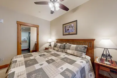 a bedroom with a bed and a ceiling fan at Lodestar Cabins in Mammoth Lakes