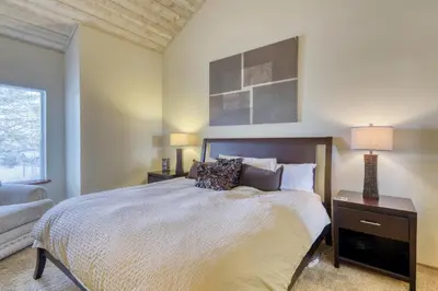 a bedroom with a bed and a couch and a window at Snowcreek 590 in Mammoth Lakes