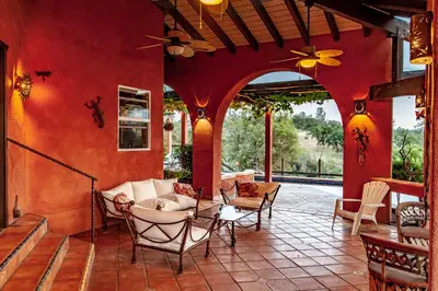 a living room with red walls and a patio at Posada Mariana Bed and Breakfast in Catheys Valley