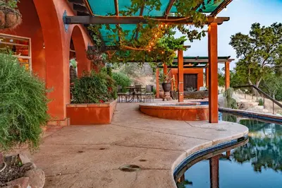 an orange building with a swimming pool and a patio at Posada Mariana Bed and Breakfast in Catheys Valley