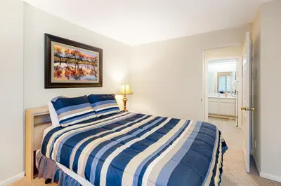 a bedroom with a blue and white striped bed at The Summit 207 in Old Mammoth