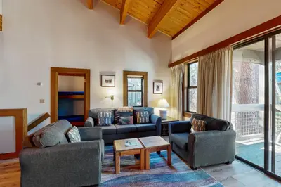 a living room with two couches and a table at Great Northstar Condo in Kingswood Estates