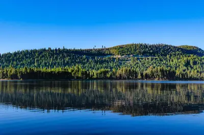 a reflection of a mountain in a lake at Donner Lakefront Retreat in Truckee