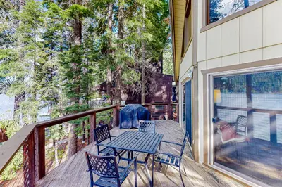a porch with a table and chairs on a deck at Donner Lakefront Retreat in Truckee