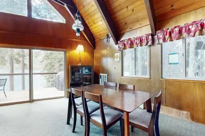 a dining room with a wooden table and chairs at Donner Lakefront Retreat in Truckee