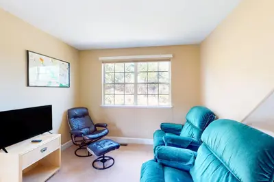 a living room with a blue couch and two chairs at Great Escape Cabin (08/253) in Groveland