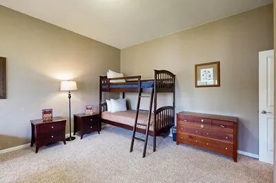 a bedroom with a bunk bed and a dresser at Mule Deer Cabin (4-538) in Groveland