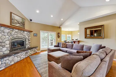 a living room with a couch and a fireplace at Mule Deer Cabin (4-538) in Groveland