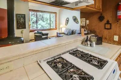 a kitchen with a stove top oven next to a counter at Northstar Ski Trails in Truckee