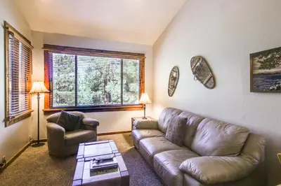 a living room with a leather couch and a chair at Northstar Ski Trails in Truckee