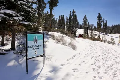 a sign in the snow next to a ski slope at Northstar Ski Trails in Truckee
