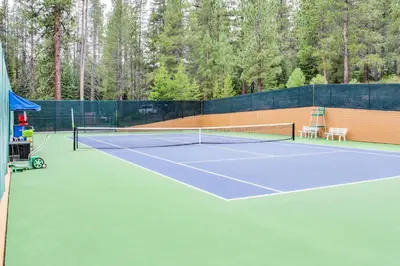 a tennis court with two chairs and a net at Northstar Ski Trails in Truckee
