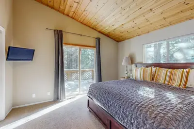 a bedroom with a bed and a large window at Jade House in Truckee
