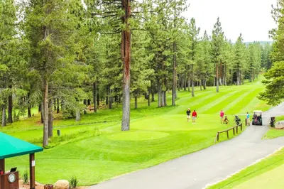 a group of people playing golf on a golf course at Jade House in Truckee