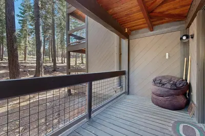 a porch with a large ottoman on the front at Aspen Grove Studio at Northstar in Truckee