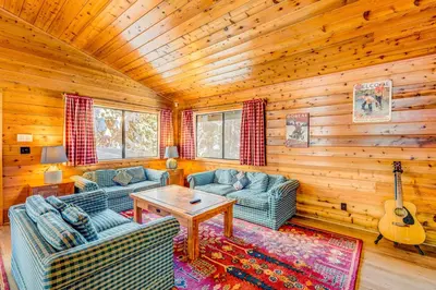 a living room with two couches and a guitar in a cabin at Ford Family Escape in Truckee