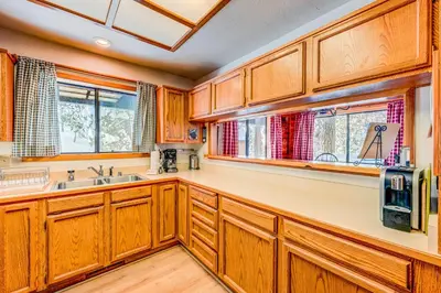 a kitchen with wooden cabinets and a sink at Ford Family Escape in Truckee