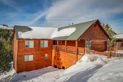 a wooden house with snow on the roof at Hillside View Vacation Home in Truckee