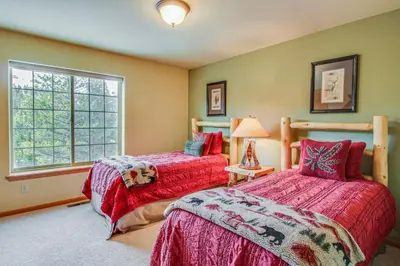 a bedroom with two beds and a window at Hillside View Vacation Home in Truckee