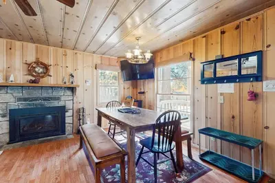 a dining room with a table and a fireplace at Cozy Bobby Grey Manor in South Lake Tahoe