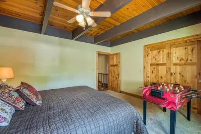 a bedroom with a bed and a wooden ceiling at Tahoe Keys Waterfront with Dock in South Lake Tahoe