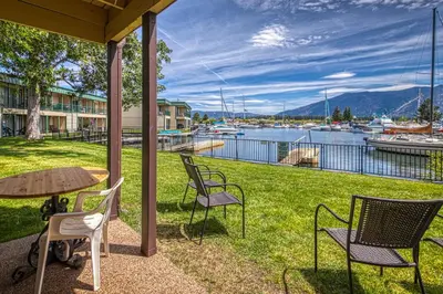 a patio with chairs and a table with a view of a marina at Tahoe Keys Waterfront with Dock in South Lake Tahoe