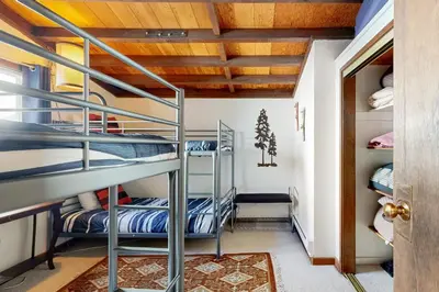 a bunk bed room with bunk beds and a hallway at Squaw Valley Views Condo #15 in Olympic Valley
