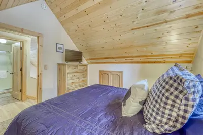 a bedroom with a bed with a wooden ceiling at Snowpeak Chalet in Tahoe Donner in Truckee