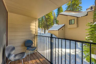two chairs on the balcony of a house at Carnelian Woods Sanctuary in Carnelian Bay