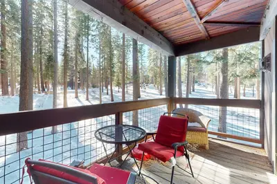 a screened in porch with chairs and a table at Aspen Grove Hideaway in Truckee