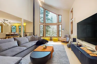 a living room with a couch and a large tv at Sierra Solstice in Truckee