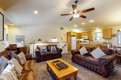 a living room with two couches and a table at Wanderlust Cabin in Kings Beach