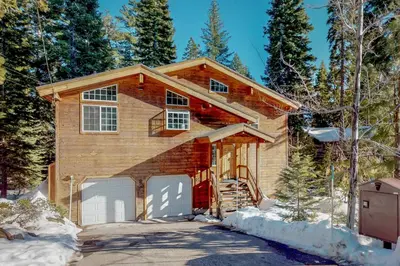 a house with a garage in the snow at Fawn Lodge in Tahoe Vista