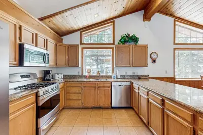 a kitchen with wooden cabinets and a counter top at Fawn Lodge in Tahoe Vista