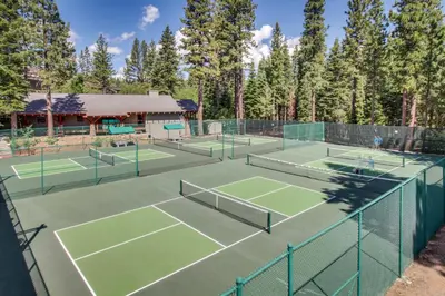 a group of tennis courts with trees in the background at Northstar Original Village Studio One in Truckee