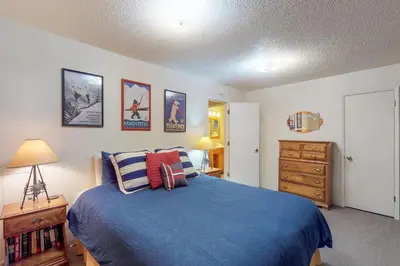 a bedroom with a blue bed and a wooden dresser at West Shore Lakeview Beauty* in Homewood