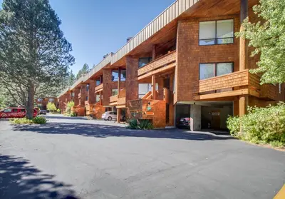 an empty parking lot in front of a brick building at Christy Lane Condo in Olympic Valley