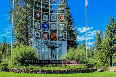 a tall glass building with a sign in front of it at Christy Lane Condo in Olympic Valley
